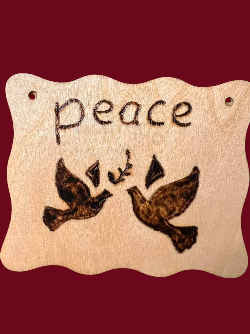 The Wooden Stuff Shop & Crafts rustic wooden wall plaque featuring a hand-burned peace sign with two doves and olive branch